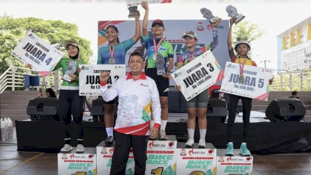 Kepala Dispora Kota Makassar bersama para pemenang kategoriCriterium Putri Makassar Bike Race 2026 saat penyerahan trofi dan hadiah di Lapangan Karebosi